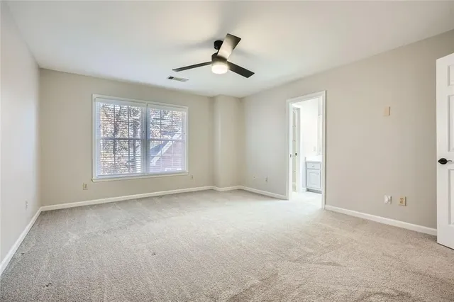 a bathroom with a granite countertop sink two mirror and a shower