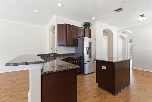 a kitchen with granite countertop a refrigerator and a stove