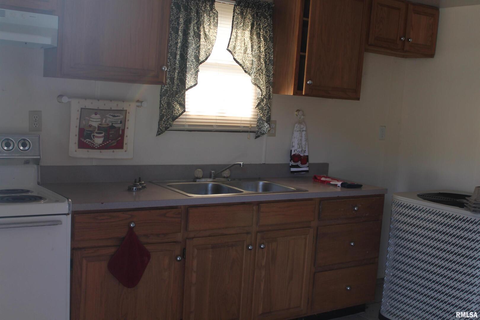 511 South Ash Street, Unit 3 Carbondale, IL 62901 - Photo 13 of 17 a bathroom with a sink vanity granite and a mirror