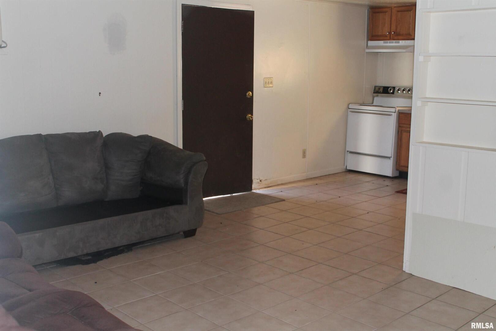 511 South Ash Street, Unit 3 Carbondale, IL 62901 - Photo 14 of 17 a living room with a couch and a stove top oven