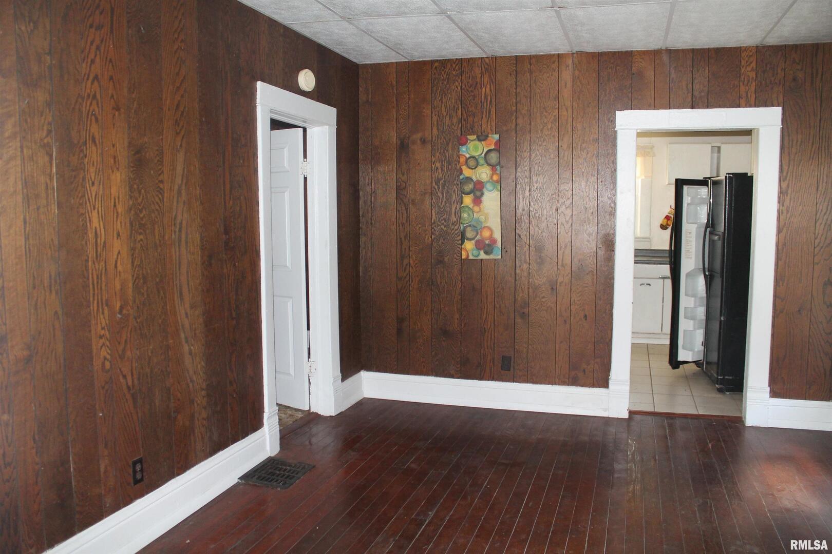 511 South Ash Street, Unit 3 Carbondale, IL 62901 - Photo 5 of 17 an empty room with wooden floor and closet