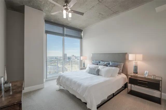 a bedroom with a bed and a night stand