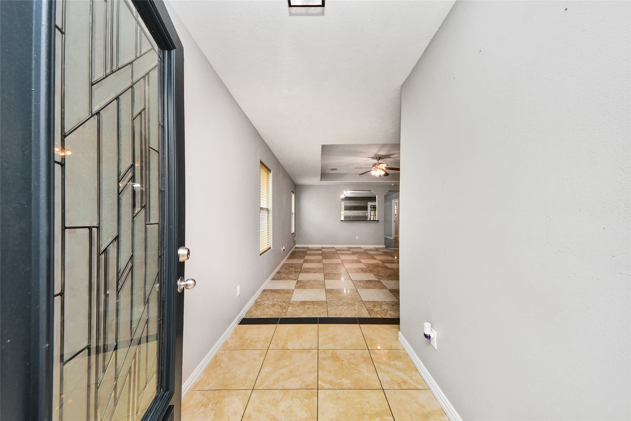 24019 Kingbriar Drive Spring, TX 77373 - Photo 8 of 41 Step through the decorative glass front door into a bright entry hall featuring neutral tones and easy-to-maintain tile flooring that flows throughout the main living areas.