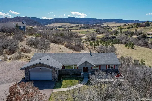 an aerial view of a house with a mountain view