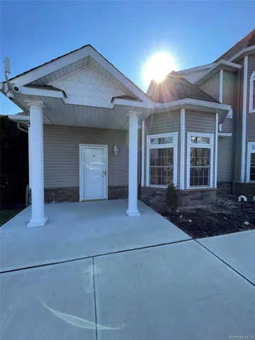a view of a house with backyard and garage