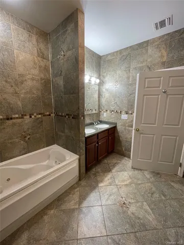 a bathroom with a sink double vanity and a mirror