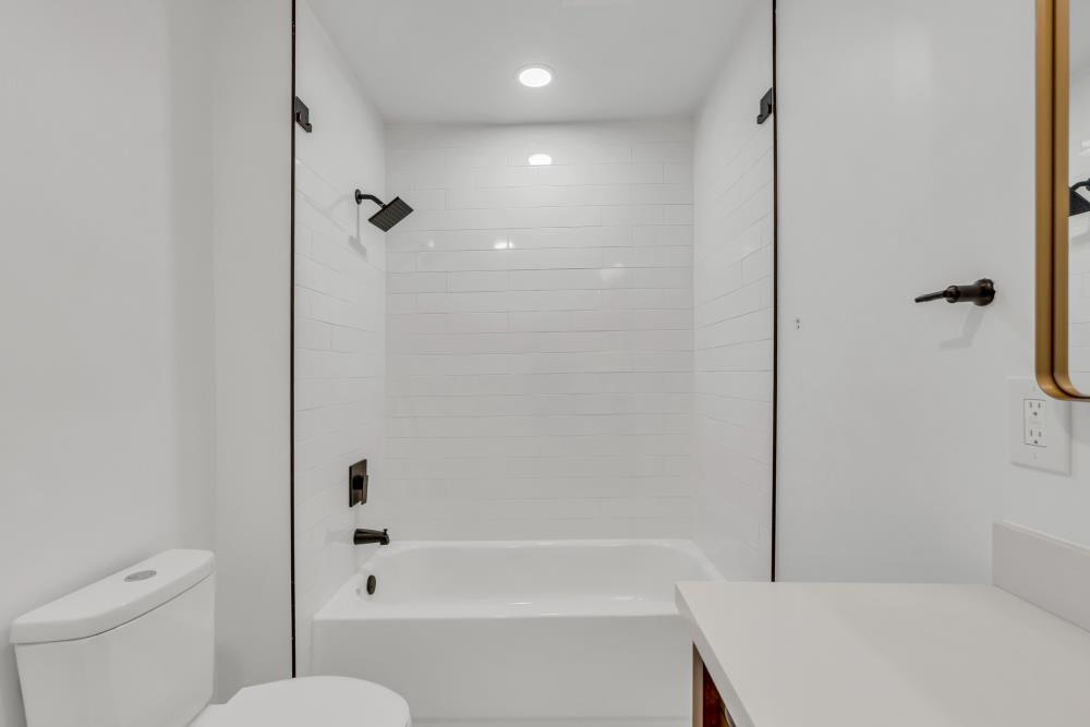 2437 Acton Street Berkeley, CA 94702 - Photo 16 of 54 a bathroom with a bathtub a toilet and a shower