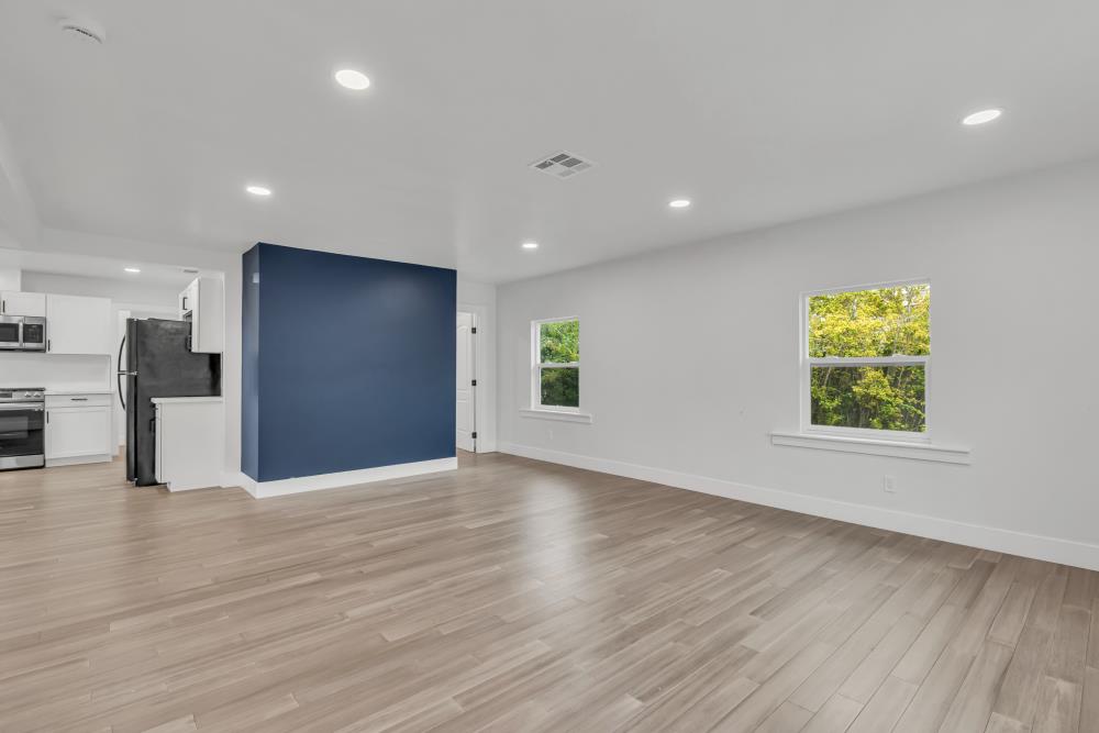 2437 Acton Street Berkeley, CA 94702 - Photo 8 of 54 a view of an empty room with wooden floor and a window