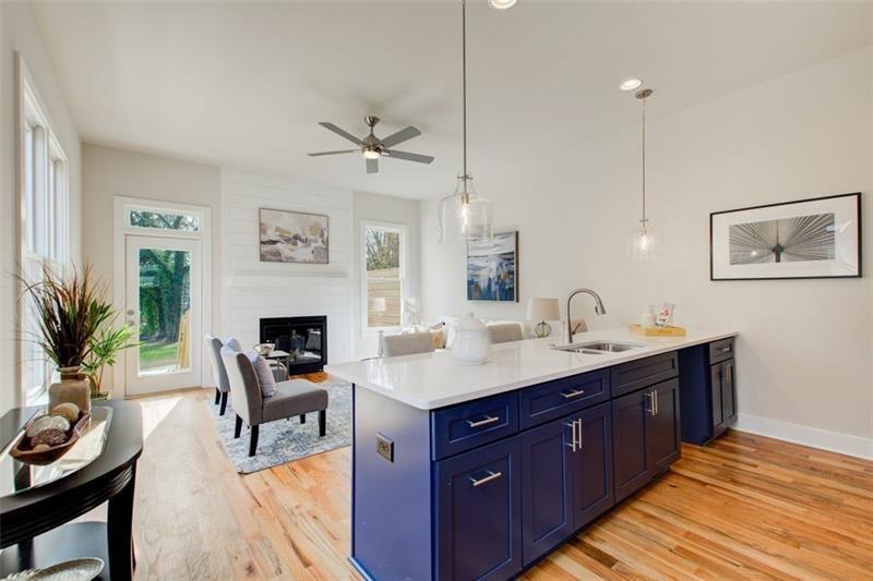 1240 Oakland Terrace Southwest, Unit B Atlanta, GA 30310 - Photo 14 of 43 a kitchen with a stove a sink and a refrigerator with wooden floor