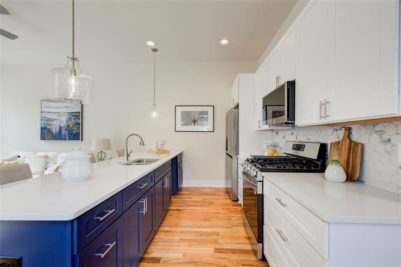 1240 Oakland Terrace Southwest, Unit B Atlanta, GA 30310 - Photo 15 of 43 a kitchen with stainless steel appliances a sink stove and refrigerator
