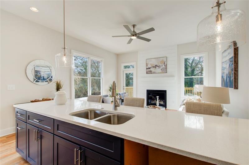 1240 Oakland Terrace Southwest, Unit B Atlanta, GA 30310 - Photo 16 of 43 a kitchen with a sink a chandelier and a fireplace