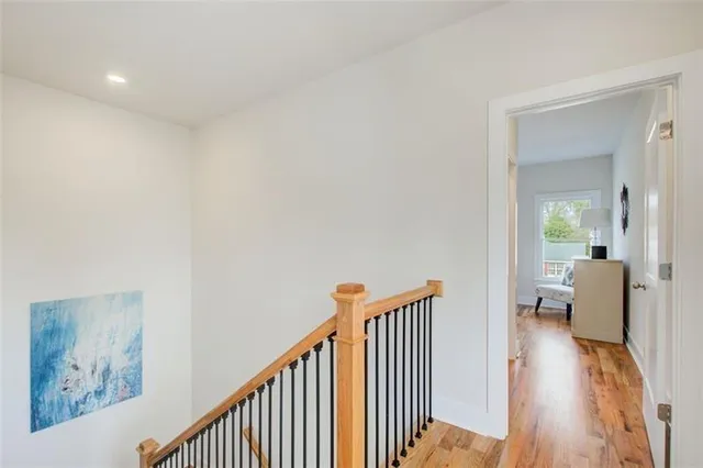a view of a hallway with wooden floor and furniture