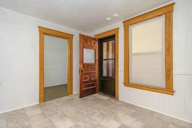 an empty room with closet and windows