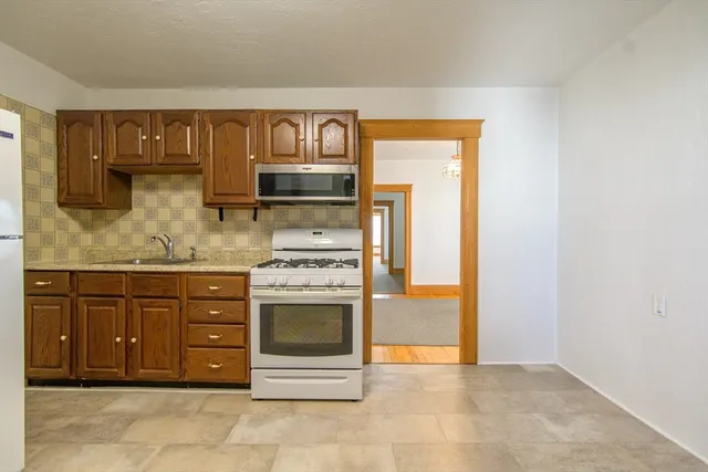 a kitchen with stainless steel appliances granite countertop a stove and a sink