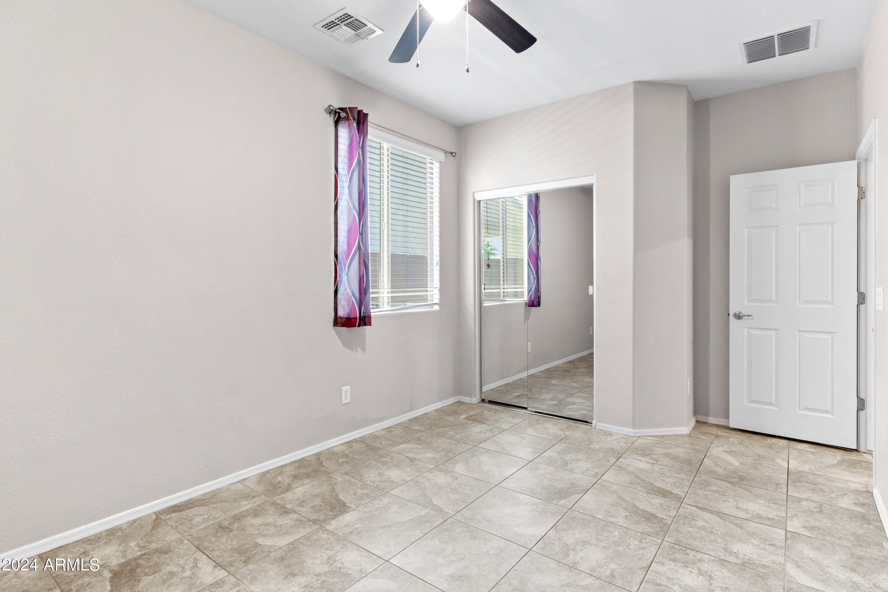 5515 West Hackamore Drive Phoenix, AZ 85083 - Photo 12 of 35 an empty room with fan and windows