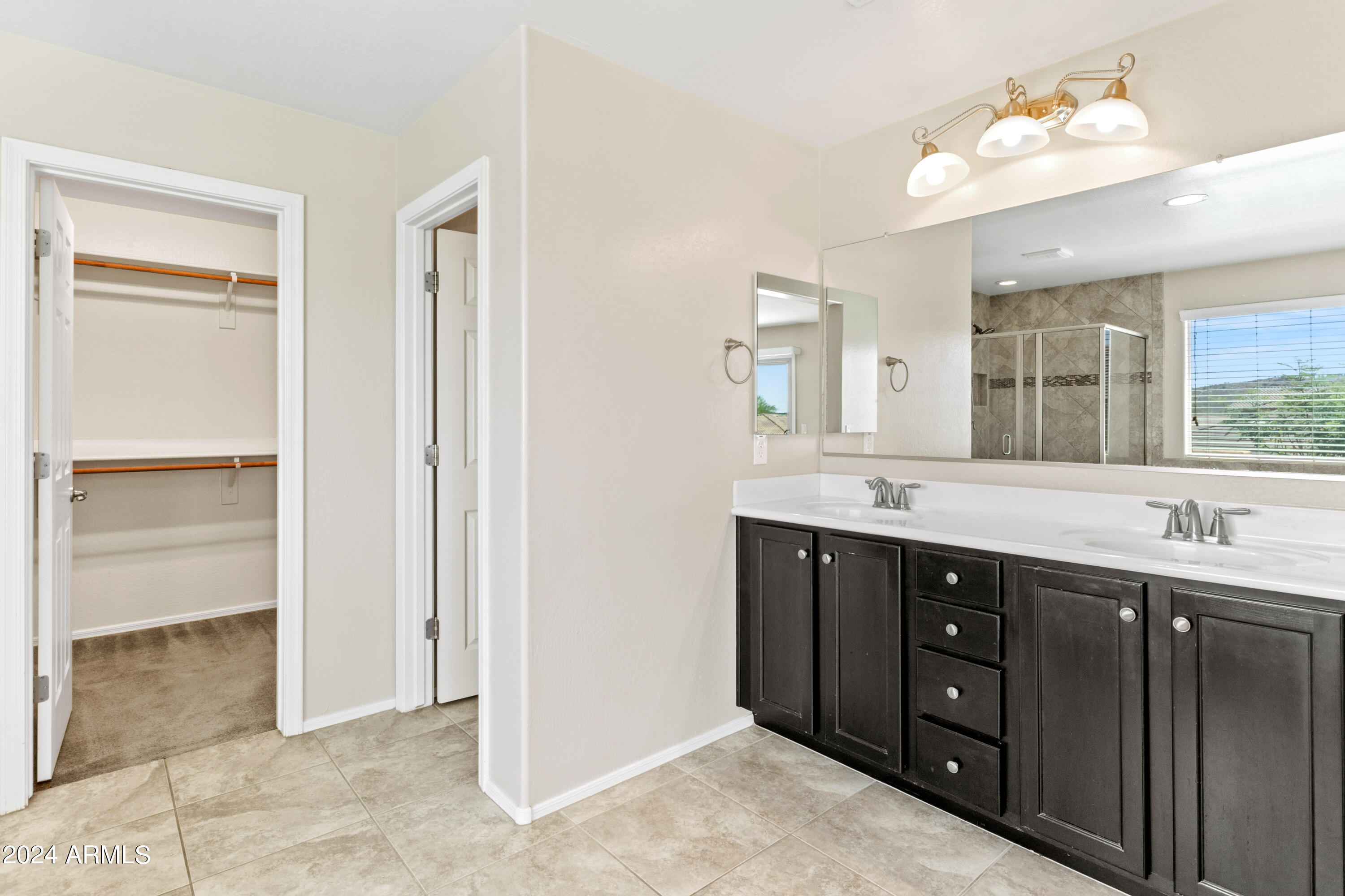 5515 West Hackamore Drive Phoenix, AZ 85083 - Photo 19 of 35 a bathroom with a double vanity sink and a mirror