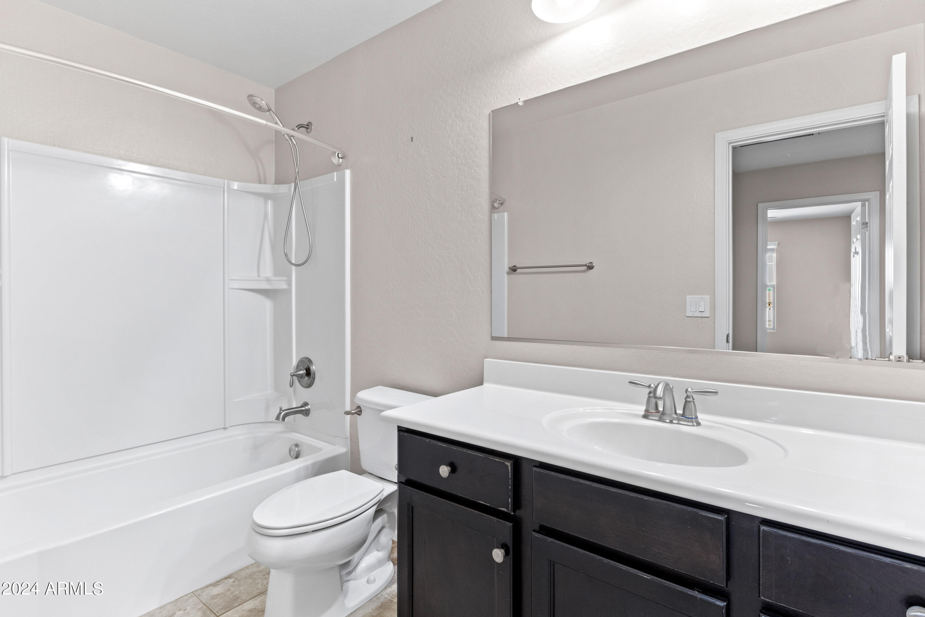 5515 West Hackamore Drive Phoenix, AZ 85083 - Photo 23 of 35 a bathroom with a sink a toilet a mirror a bathtub and shower