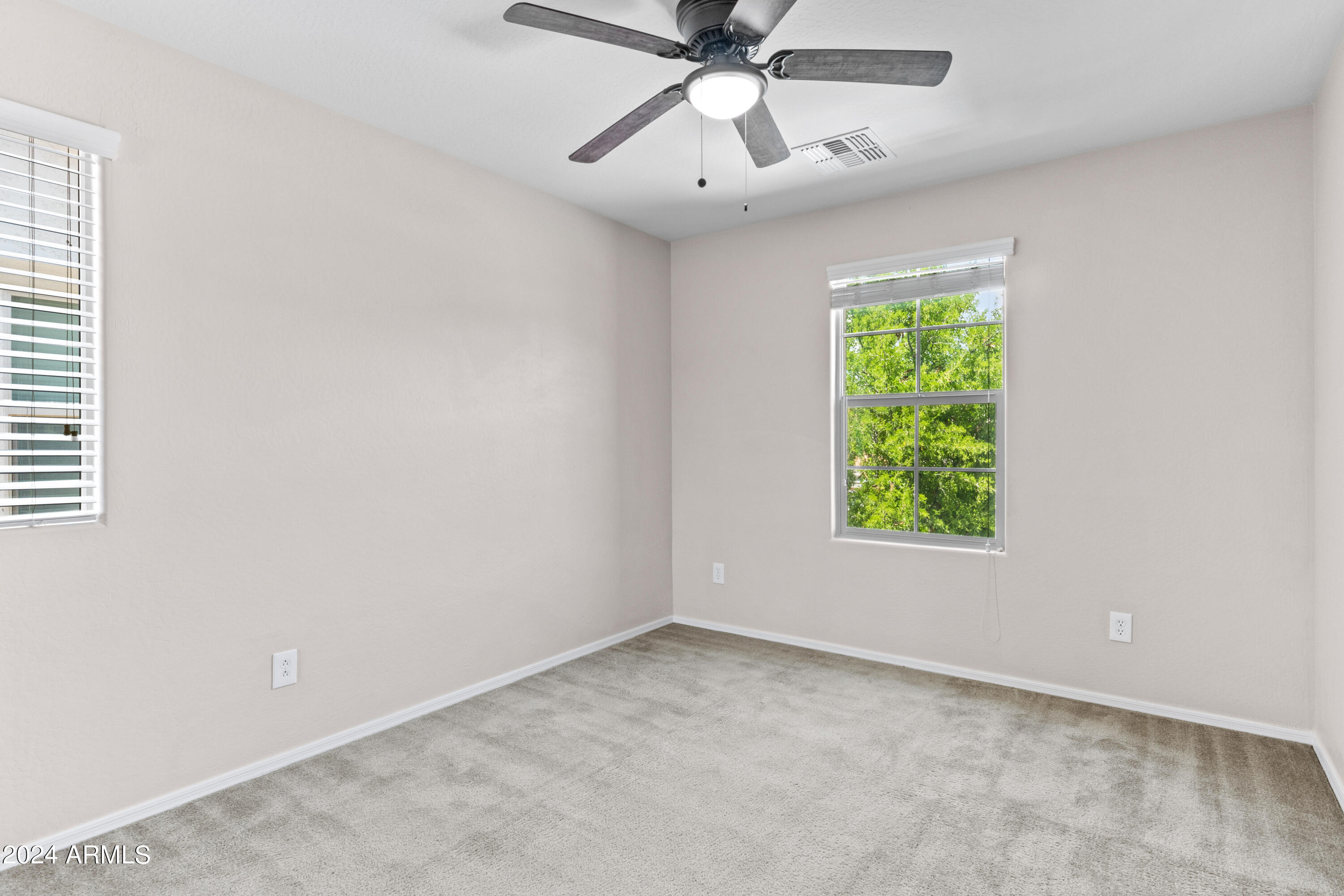 5515 West Hackamore Drive Phoenix, AZ 85083 - Photo 24 of 35 an empty room with a window and a fan