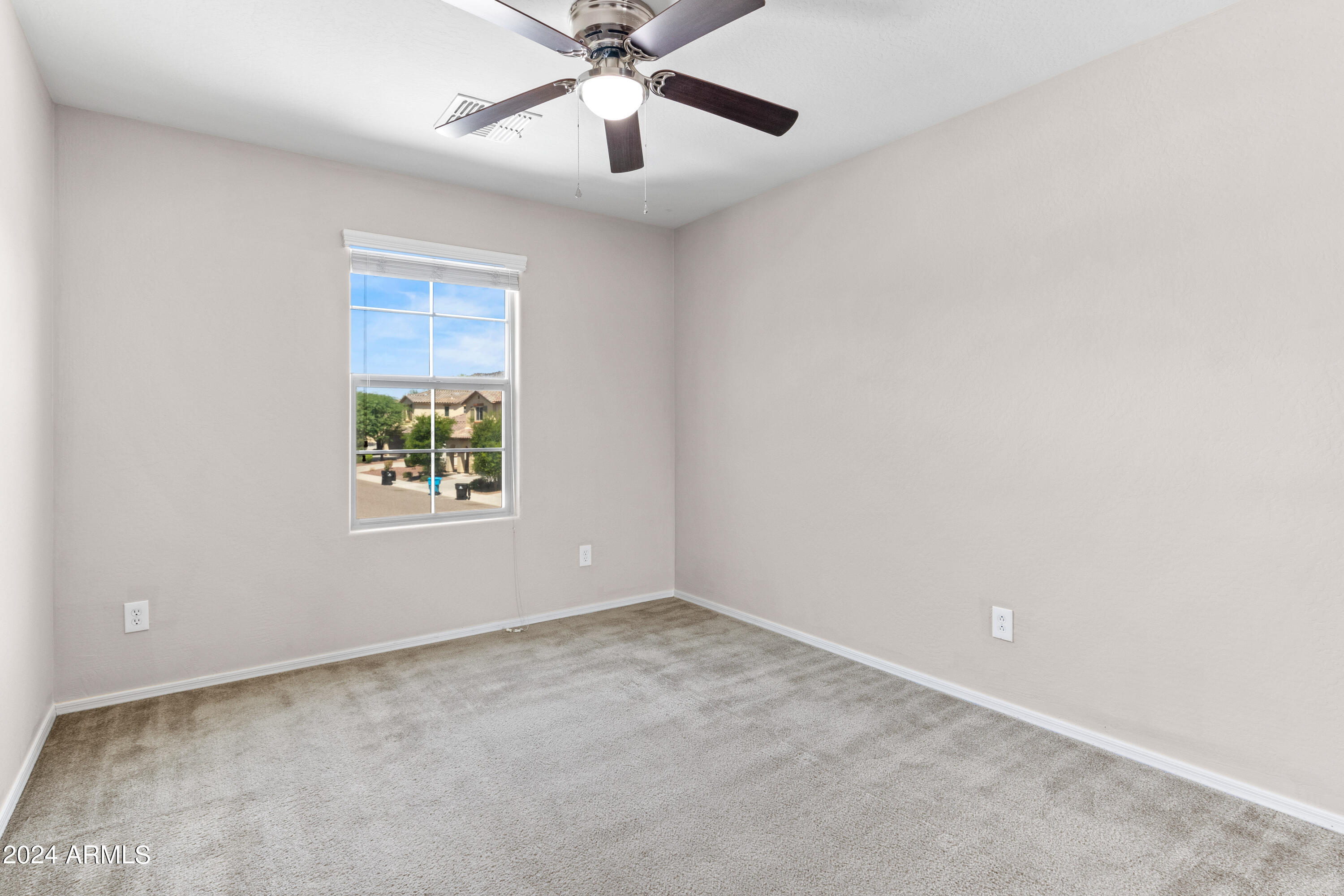 5515 West Hackamore Drive Phoenix, AZ 85083 - Photo 25 of 35 an empty room with a window and a fan
