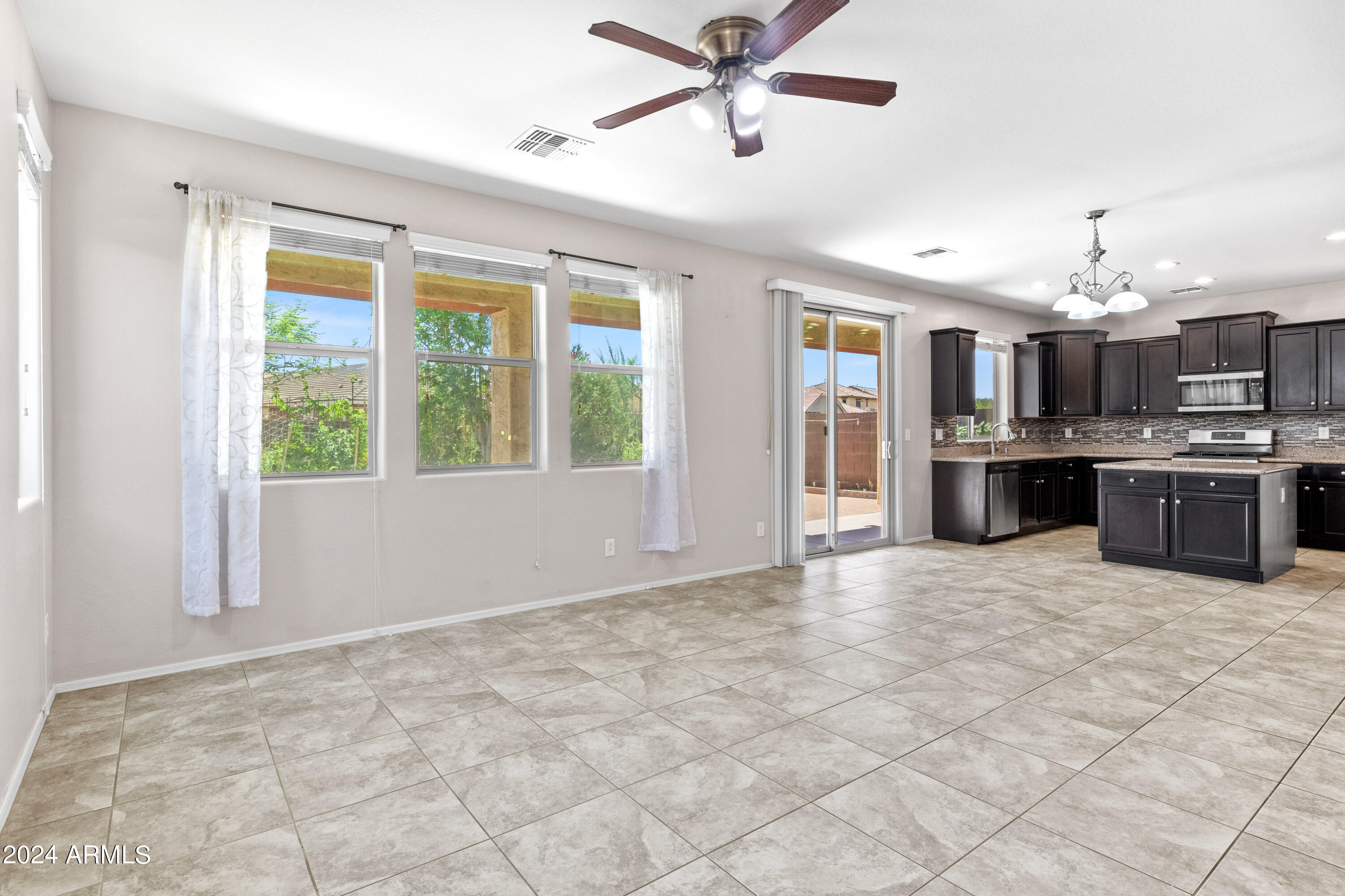 5515 West Hackamore Drive Phoenix, AZ 85083 - Photo 3 of 35 a view of a kitchen with a stove cabinets and a ceiling fan