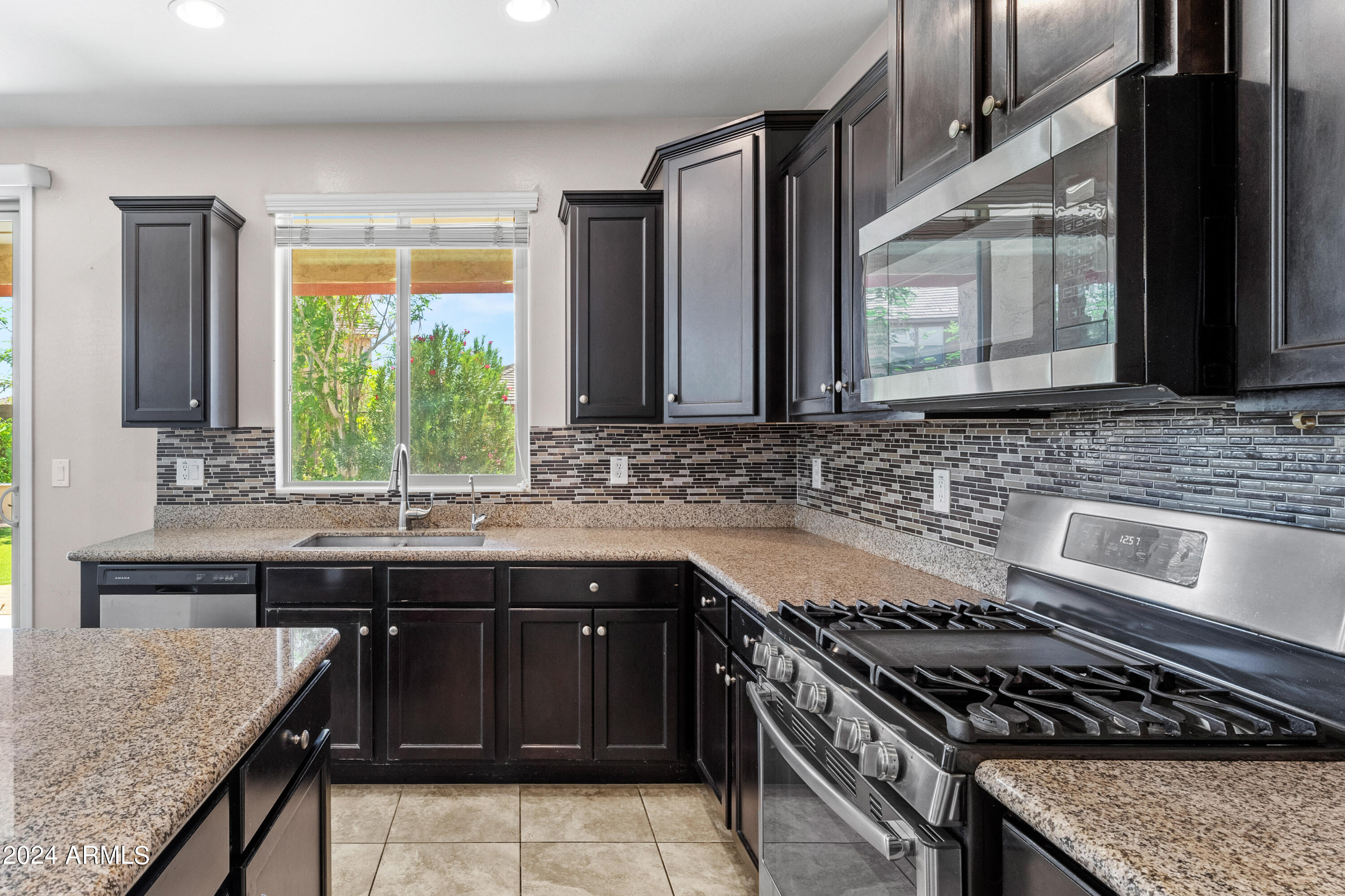 5515 West Hackamore Drive Phoenix, AZ 85083 - Photo 6 of 35 a kitchen with stainless steel appliances granite countertop a sink stove and refrigerator