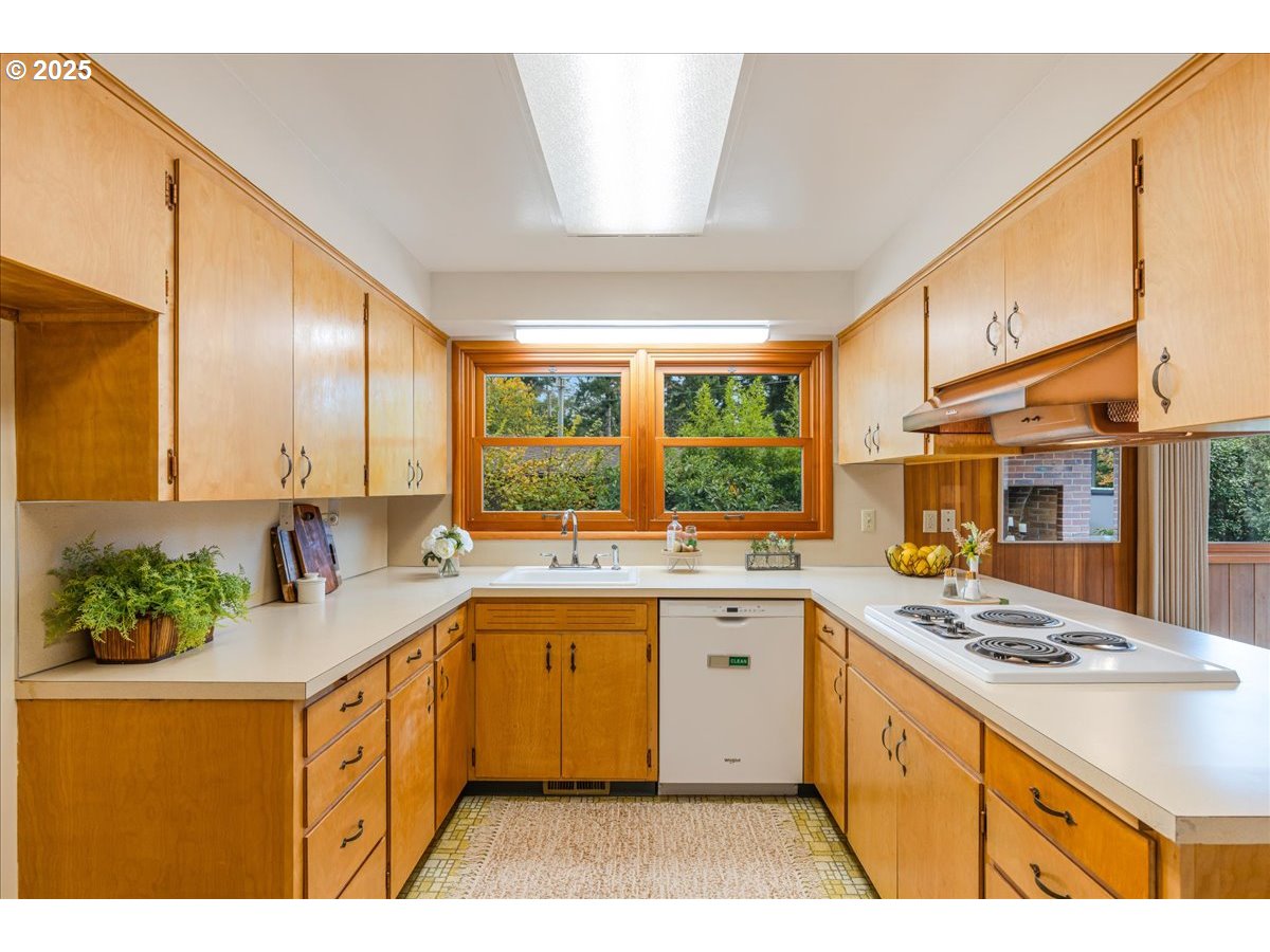 11030 Northeast Davis Street Portland, OR 97220 - Photo 20 of 48 a kitchen with a sink stove and cabinets