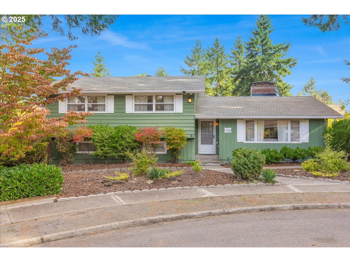 11030 Northeast Davis Street Portland, OR 97220 - Photo 2 of 48 a front view of a house with a yard