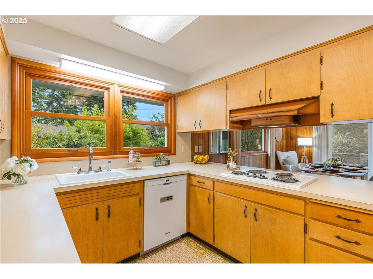 11030 Northeast Davis Street Portland, OR 97220 - Photo 21 of 48 a kitchen with a sink stove and cabinets