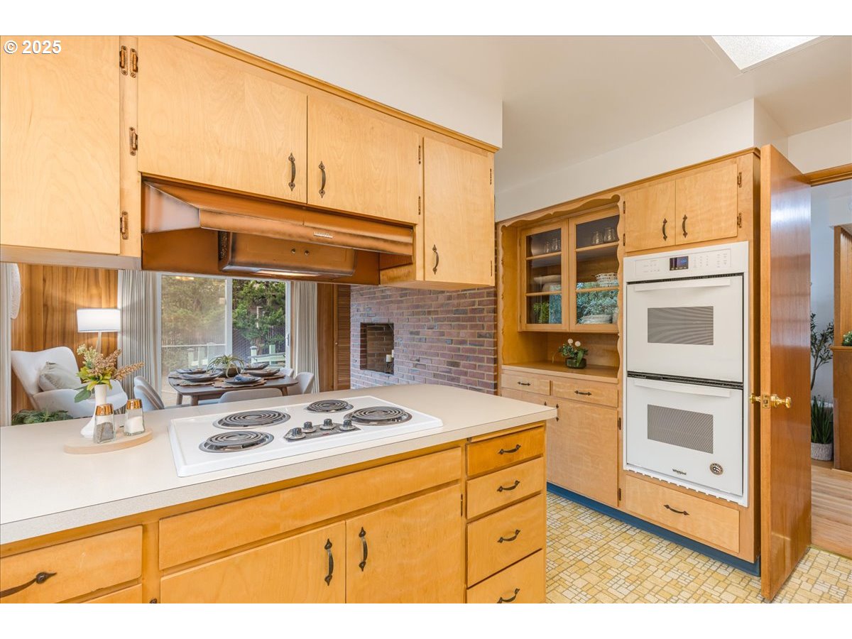 11030 Northeast Davis Street Portland, OR 97220 - Photo 22 of 48 a kitchen with stainless steel appliances kitchen island granite countertop a sink and cabinets