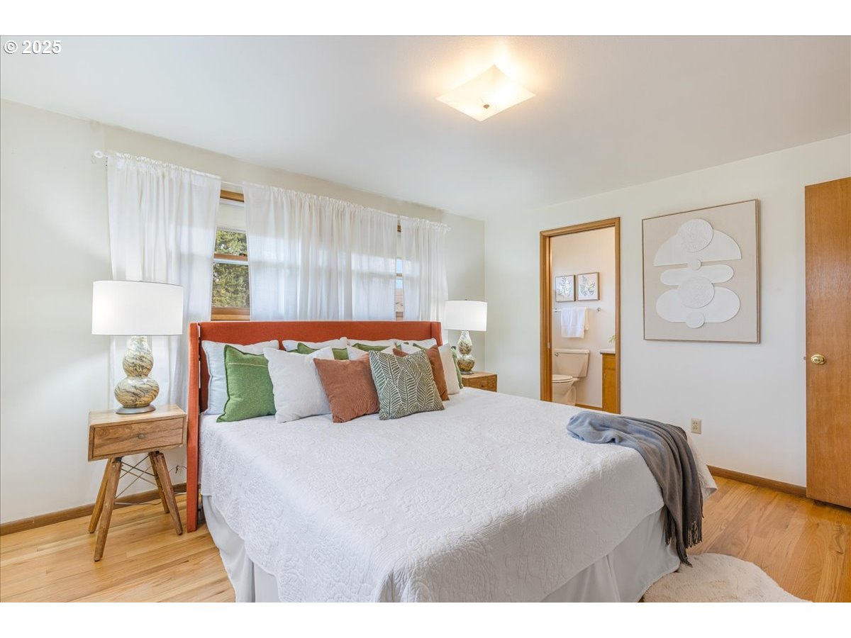 11030 Northeast Davis Street Portland, OR 97220 - Photo 24 of 48 a bedroom with a bed and a table