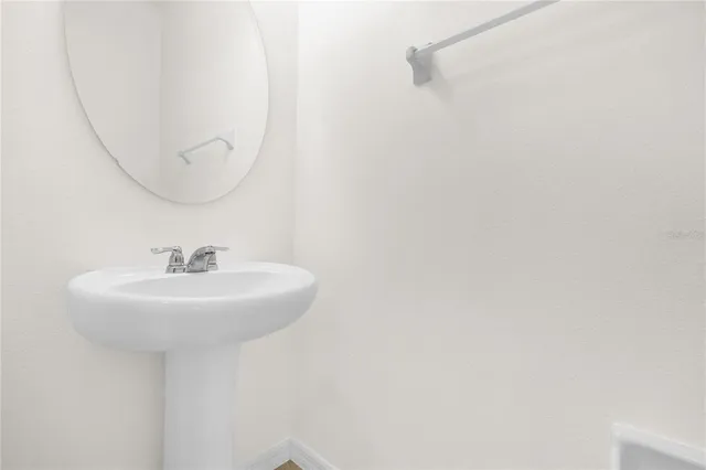 a bathroom with a sink a mirror and a shower