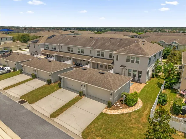 an aerial view of residential houses with outdoor space and river view