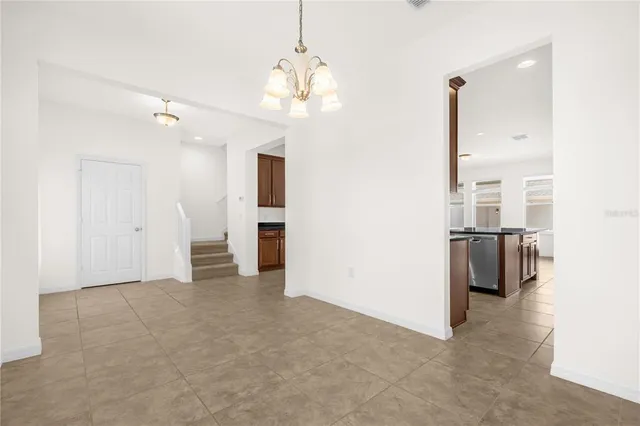 a view of a kitchen with a sink and refrigerator