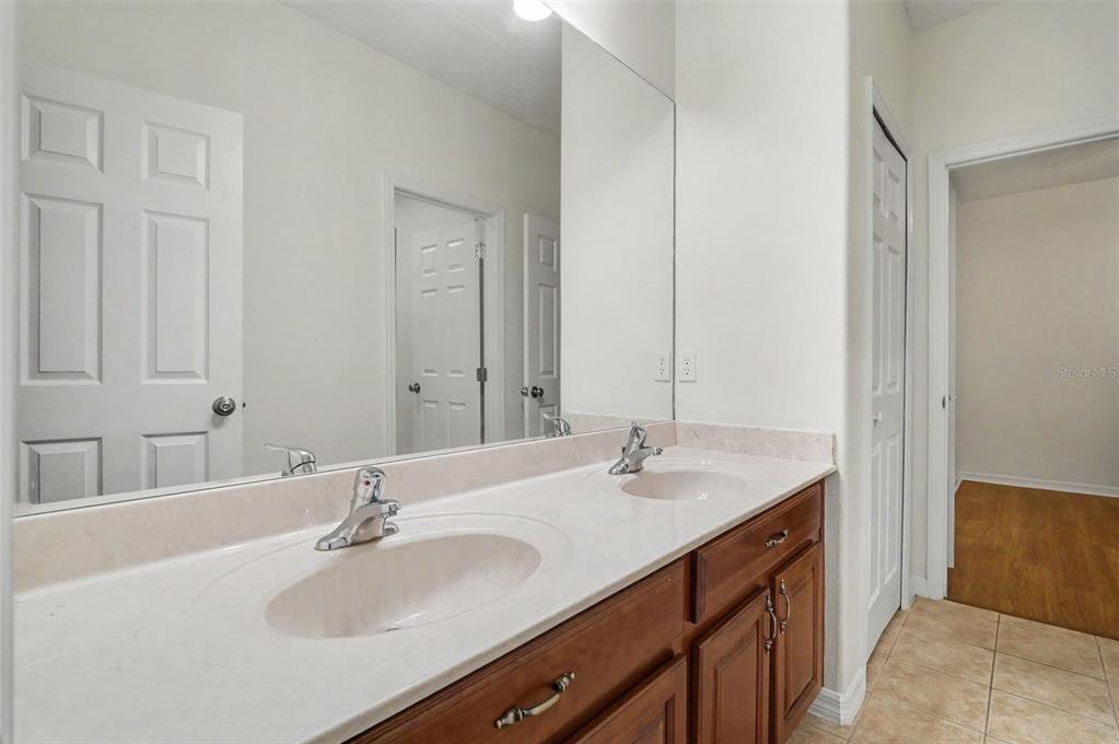 4819 Indian Deer Road Windermere, FL 34786 - Photo 28 of 30 a bathroom with double vanity sinks and a mirror