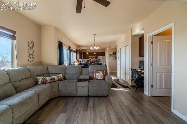 a living room with furniture and a chandelier