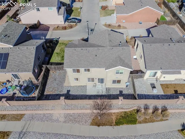 an aerial view of residential houses with outdoor space and swimming pool