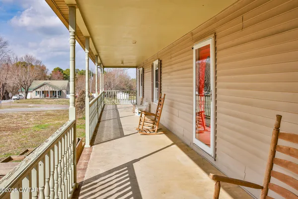 a view of a balcony with couch and wooden floor