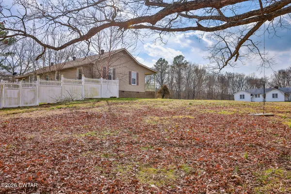 a backyard of apartments with large trees