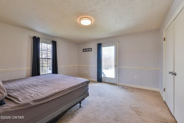 a spacious bedroom with a bed and window