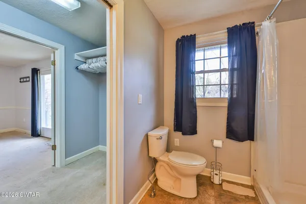 a bathroom with a toilet a sink and shower