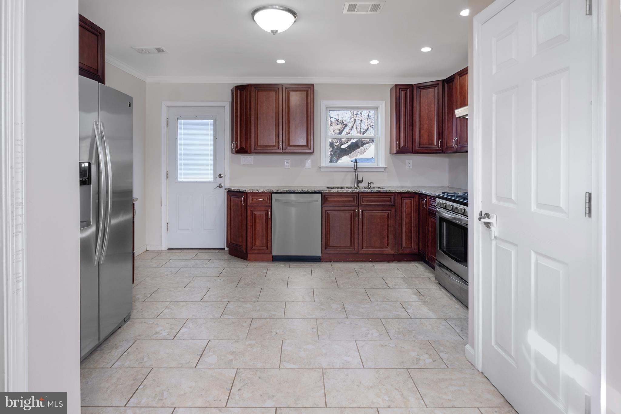 33 Gilmore Road Ewing, NJ 08628 - Photo 8 of 21 a large kitchen with stainless steel appliances granite countertop a refrigerator and a sink