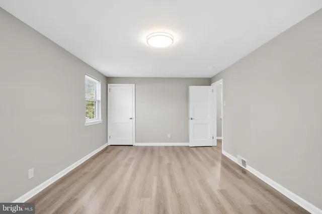 a view of room with window and wooden floor