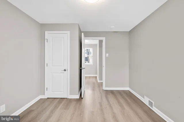 a view of hallway with wooden floor