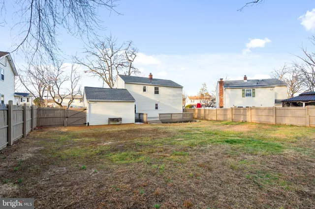 a view of a entrance gate of the house and trees