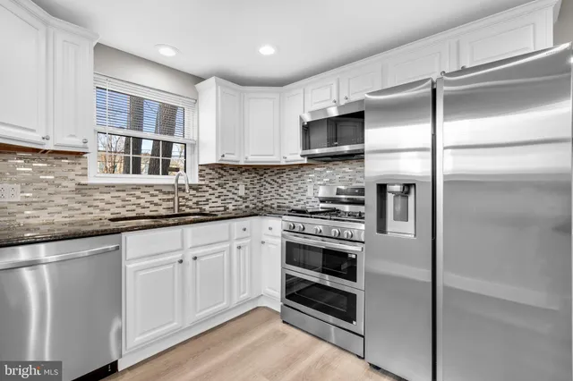 a kitchen with a refrigerator stove and sink