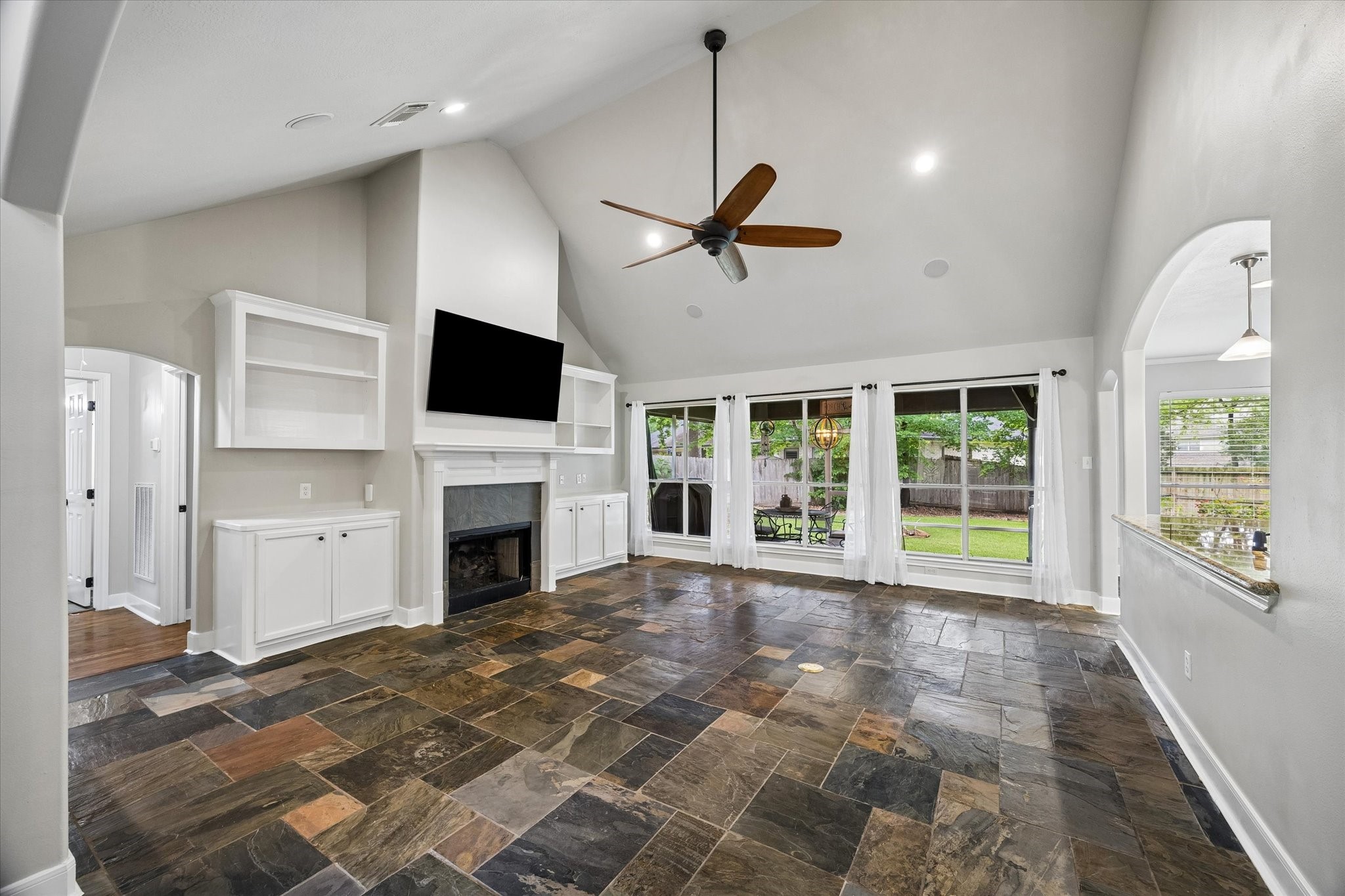 109 Dawns Edge Conroe, TX 77356 - Photo 3 of 24 a view of a livingroom with a fireplace a ceiling fan and window