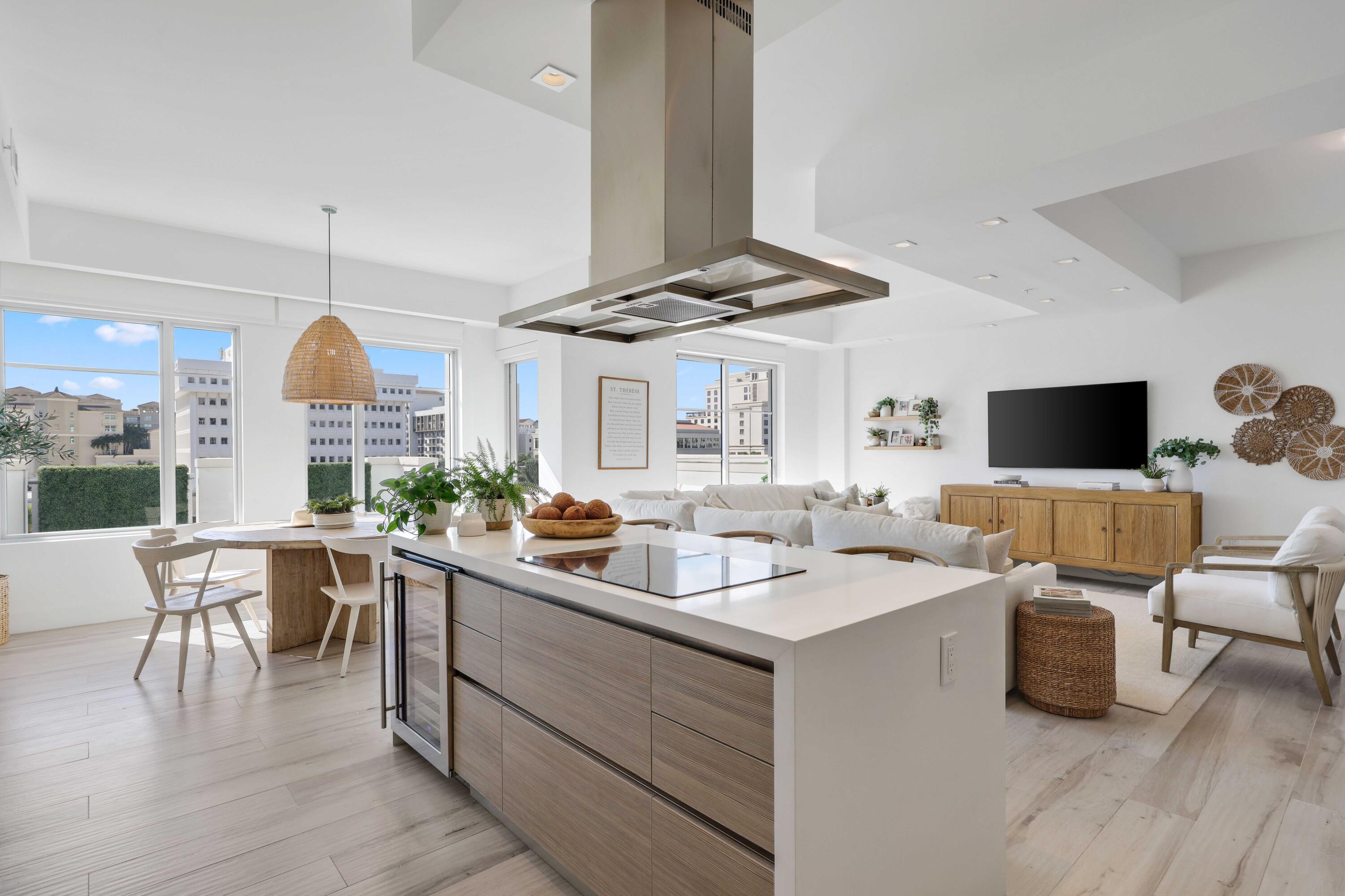 155 East Boca Raton Road, Unit 601 Boca Raton, FL 33432 - Photo 2 of 55 a kitchen with stainless steel appliances a stove a sink dishwasher and a dining table with wooden floor
