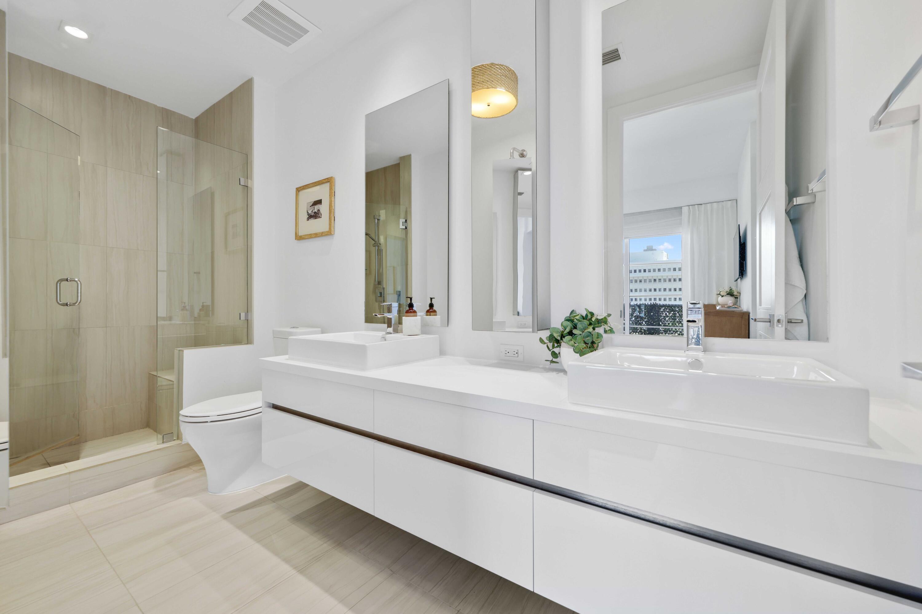 155 East Boca Raton Road, Unit 601 Boca Raton, FL 33432 - Photo 25 of 55 a spacious en suite bathroom with a double vanity sink and a mirror