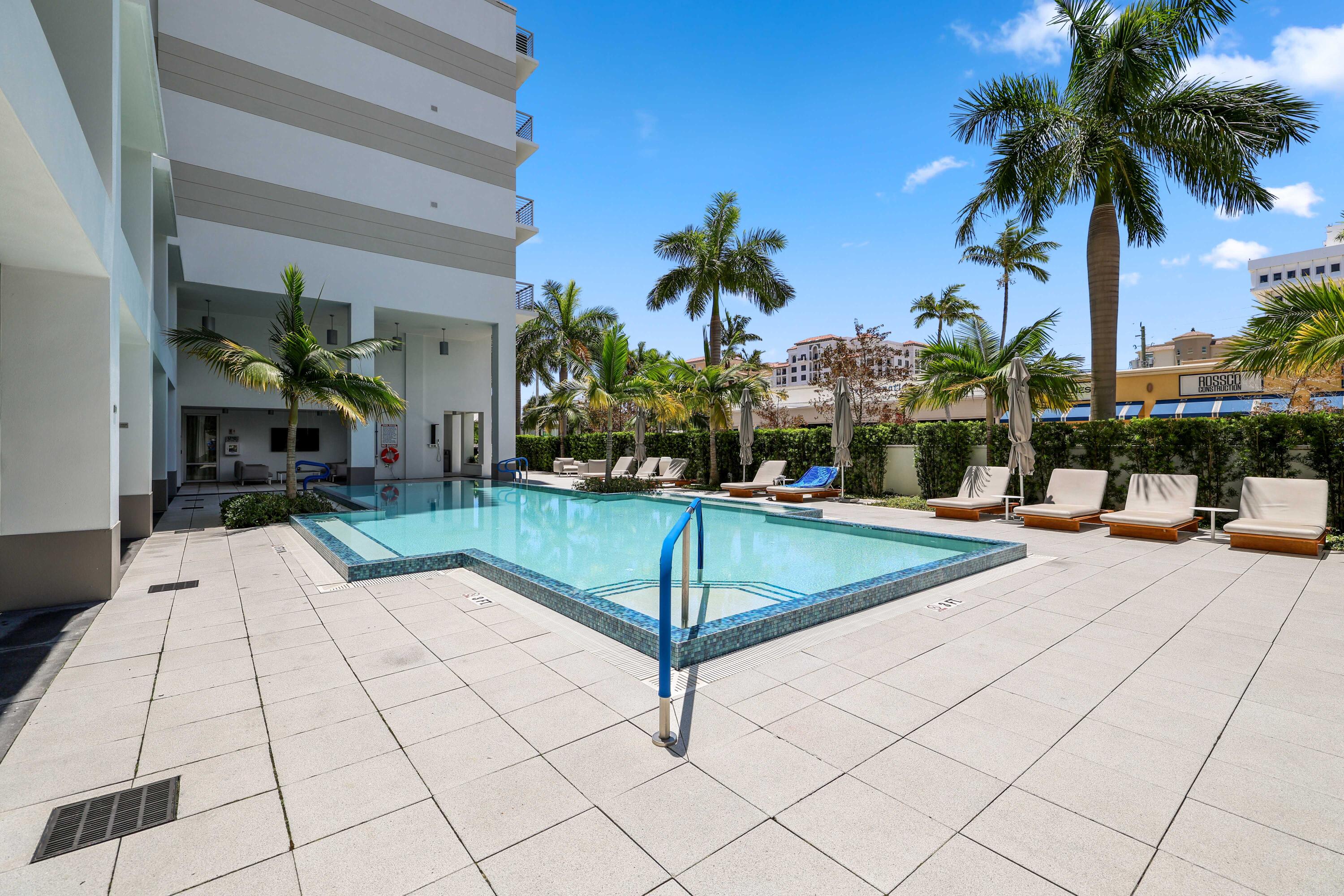 155 East Boca Raton Road, Unit 601 Boca Raton, FL 33432 - Photo 50 of 55 a swimming pool with outdoor seating and a potted plants