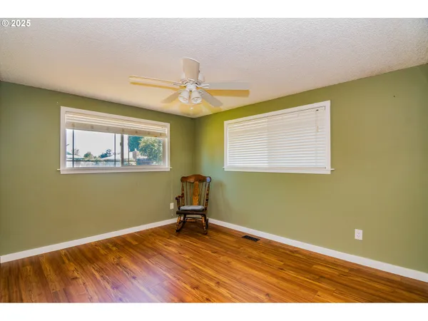a room with wooden floor and a window
